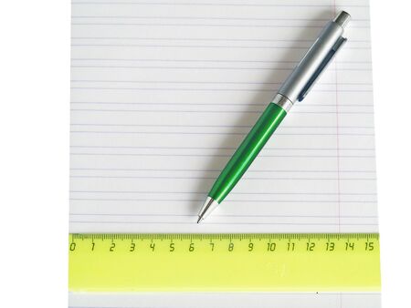 The pen and ruler lays on a school writing-book close upの写真素材