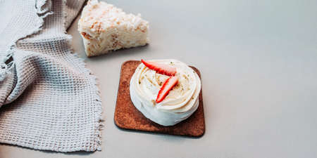 Baking banner. Pastry white souffle with cream and fresh strawberries on the kitchen light table...