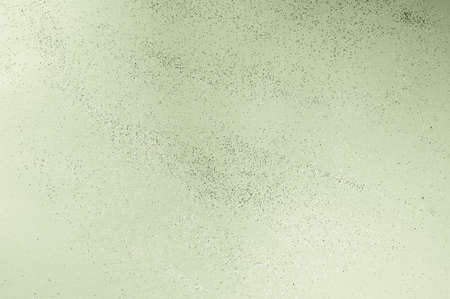 green backgdrop with silver sequins and bokeh from sequins. festive texture in chive color