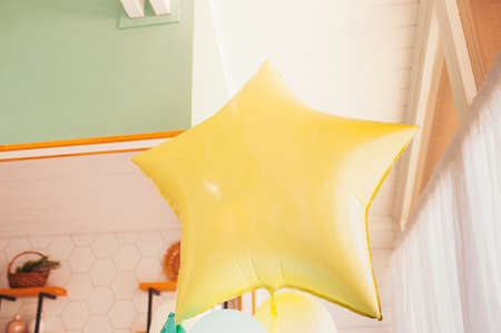 large Yellow foil ball star in the kitchen in a residential apartment.