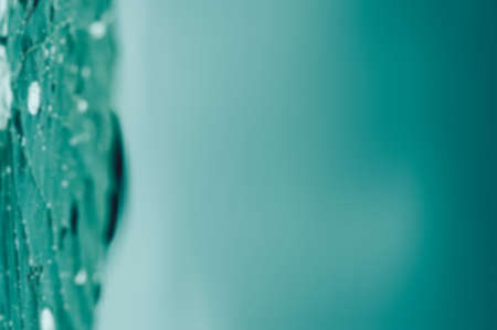 turquoise blurred abstraction with water drops and dripsの写真素材