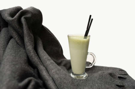 insulated matcha tea Cup with tubes on a warm gray wool blanketの写真素材