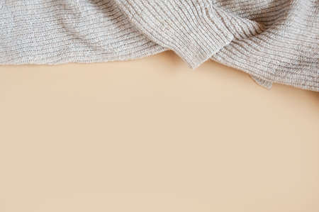 cozy large-knit wool sweater on a clean beige background, beige monochromeの写真素材