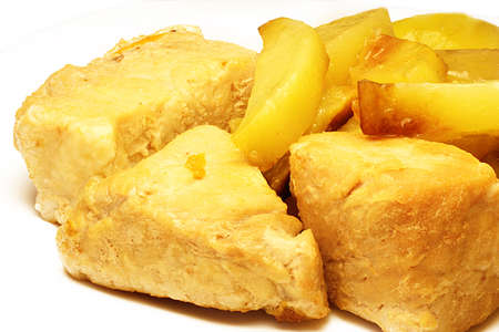 Roast pork and fried potatoes on a plateの写真素材