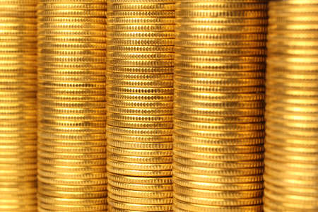 Coins from yellow metal on a white backgroundの写真素材