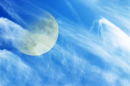 The moon and clouds in the summer skyの写真素材