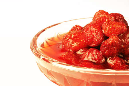 Strawberry jam in a crystal plate on a white backgroundの写真素材