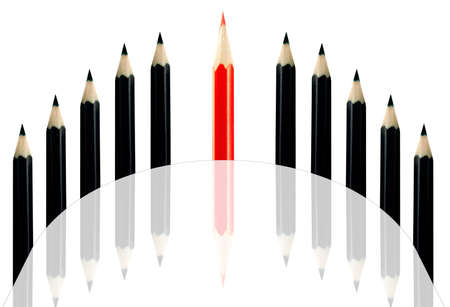 Red pencil among black pencils on a white backgroundの写真素材