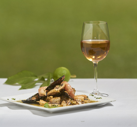 Seafood dish with white wineの写真素材