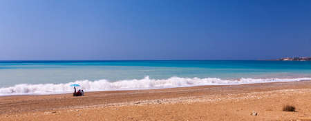 The sun beats down on a near-deserted beach in the west of Cyprusの写真素材