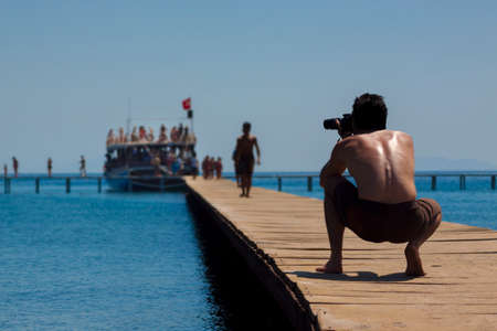 As passengers disembark from a cruise ship a photographer captures the actionの写真素材