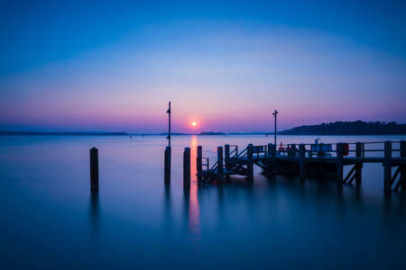 Dramatic skies over a Still Waters of a Dorset harbourの写真素材
