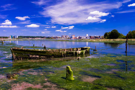 Derelict boats in the backwaters of Holes Bay, Poole Harbour at low tideの写真素材