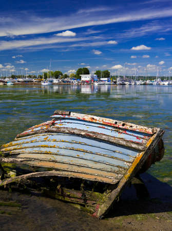 Derelict boats in the backwaters of Holes Bay, Poole Harbour at low tideの写真素材