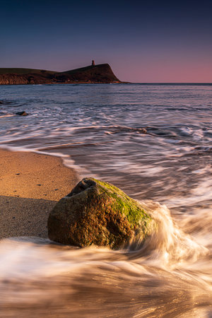 Golden hour at Kimmeridge on the Dorset Coast looking across rocks and seaの写真素材