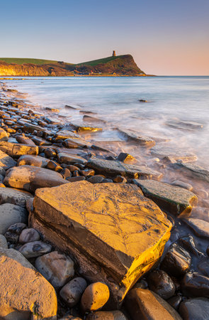 Golden hour at Kimmeridge on the Dorset Coast looking across rocks and seaの写真素材