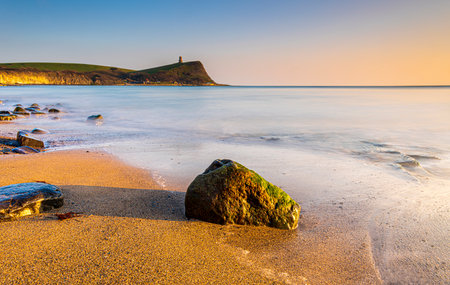 Golden hour at Kimmeridge on the Dorset Coast looking across rocks and seaの写真素材