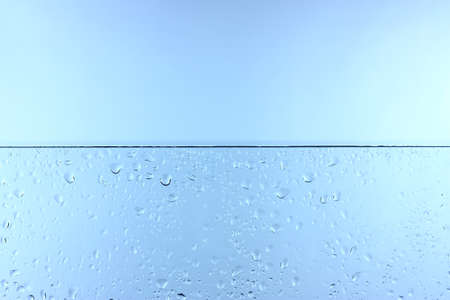 Drops on a glass and a bright, blue background