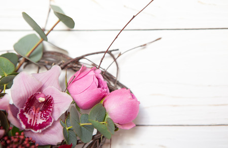 Creative flower bouquet on white wooden background. Mockup with copy space for greeting card, invitation, social media, Valentine's day, flower delivery, Mother's day, Happy Women's Day. Flat lay.の写真素材