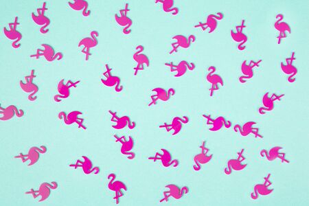 Summer tropical background, chaotic pattern made of numerous pink flamingo confetti on turquoise pastel background, flatly. Summertime, relax, joy, pool party concept. Horizontal orientation.の写真素材