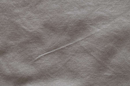 Top view, gray crumpled linen fabric background. Close-up of tea towel, napkin, tablecloth or clothing. Concept of simplicity, environmental friendliness, natural clothing, home textiles. Horizontal.の写真素材