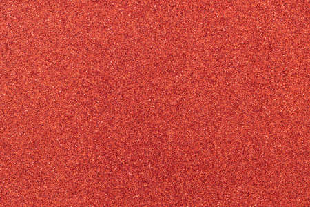 Metallic glitter scarlet red wrapping paper background, close-up, macro. Copy space for text. Horizontal and vertical. Celebration, holidays, Valentine's Day, sales concept, harvesting for mock up.の写真素材