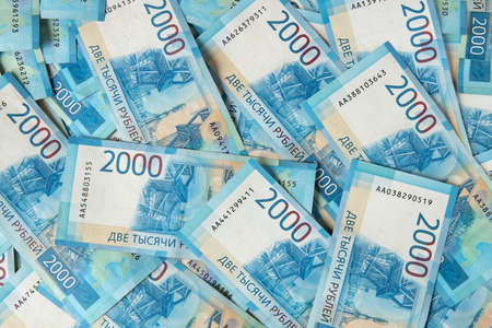 Background from Russian money, many banknotes rubles, denomination 2000. The concept of cash,...