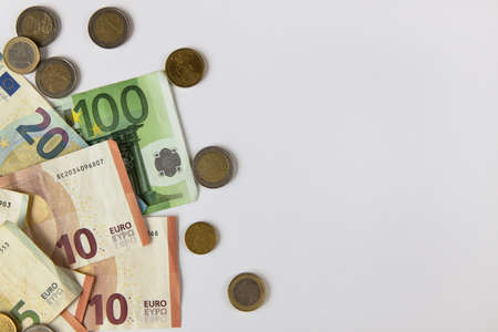 Background from euro money, copy space. Few banknotes and coins, different denomination. Concept cash, salary, wealth, sweet life, credit, finance, business, deposit, insurance. Top view, flat lay.の写真素材