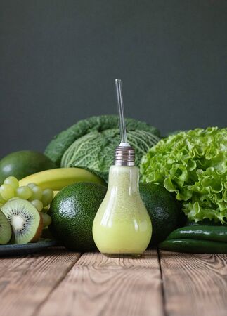 Fresh raw fruits and vegetables compositions on wooden table dark grey background. Nutritious healthy tasty delicious vegetarian vegan detox diet concept.の写真素材