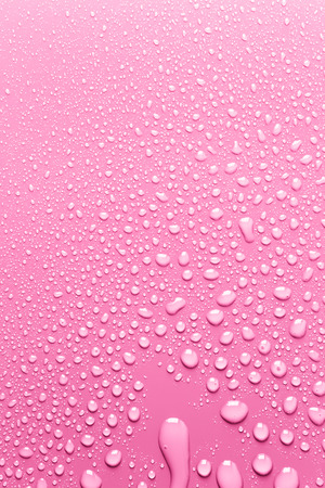 Clean surface pink with drops of waterの写真素材