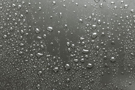Metal surface with drops of water, silvery backgroundの写真素材