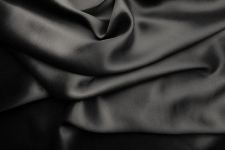 Elegant black satin silk with waves, abstract backgroundの写真素材