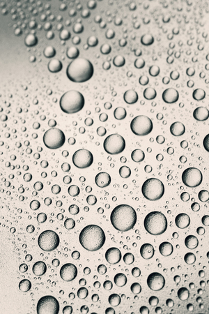 Drops of water on rough surface, abstract backgroundの写真素材