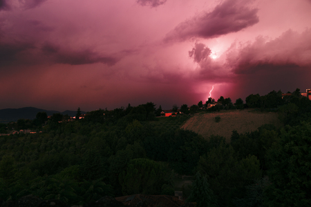 Storm in the distance at sunset, gloomy countryside landscapeの写真素材