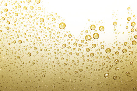 Bubbles of water on a shaded surface, golden backgroundの写真素材