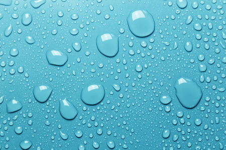 Surface with water drops, blue backgroundの写真素材