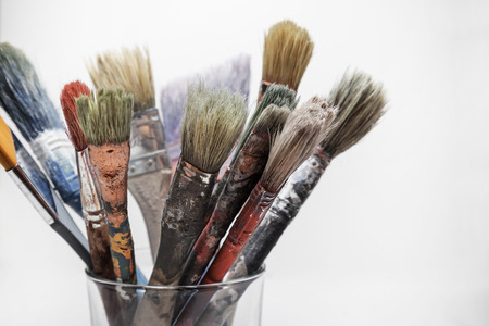 Paintbrushes in a glass, white backgroundの写真素材
