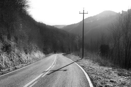 Mountain road on a winter day, black and white sceneの写真素材