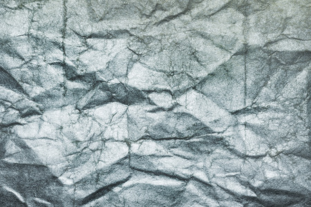 Sheet of silver paper crumpled, abstract backgroundの写真素材