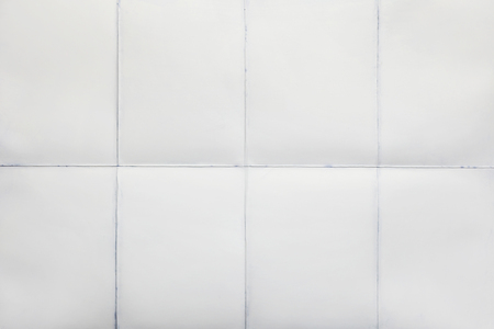 Empty sheet of paper folded in eight, white backgroundの写真素材