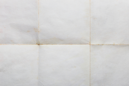 Old sheet of paper folded in six, texture backgroundの写真素材