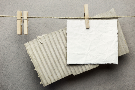 Cards hanging on a rope with clothespinsの写真素材