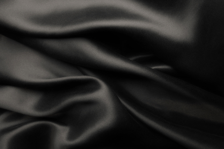 Elegant black satin silk with waves, abstract backgroundの写真素材