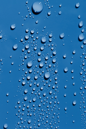 Water drops on a blue surface, abstract backgroundの写真素材