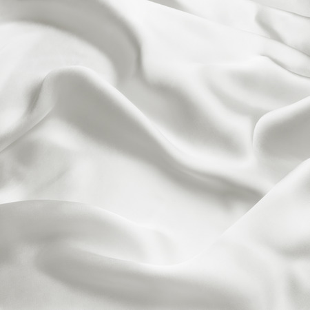 Elegant white satin silk with waves, abstract backgroundの写真素材