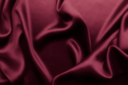 Elegant red satin silk with waves, abstract backgroundの写真素材