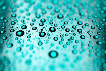 Rain on blue surface, background with many dropsの写真素材