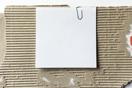 White note paper on piece of cardboardの写真素材