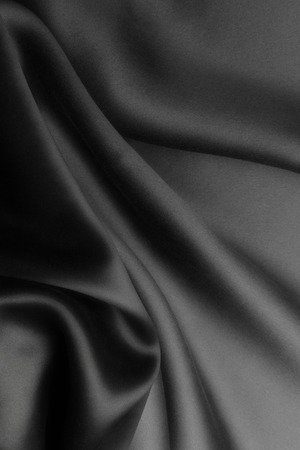 Elegant black satin silk with waves, abstract backgroundの写真素材