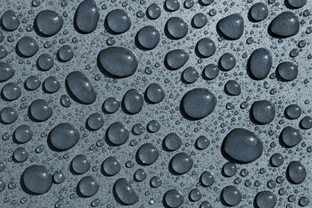 Water drops on a rough surface, texture backgroundの写真素材